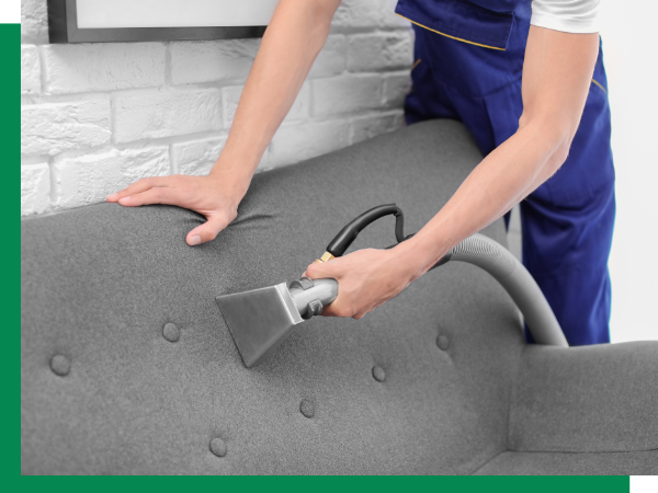 man cleaning couch upholstery
