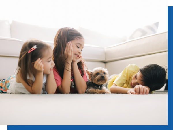 kids and their dog laying on clean carpet