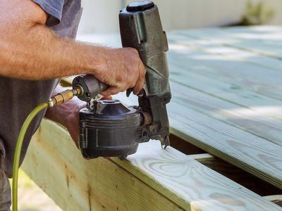 an constructing wooden deck using power tools.