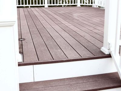 Close-up of stairs and white railing leading onto deck.