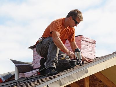 Image of a roofer installing shingles