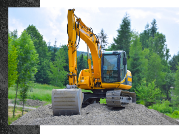 excavation equipment on gravel pile 