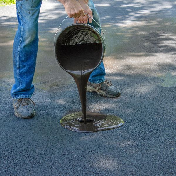 Pouring concrete sealant.
