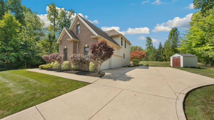 a home with a large driveway Understanding the Benefits of Sealing Your Residential Concrete Hero.jpg