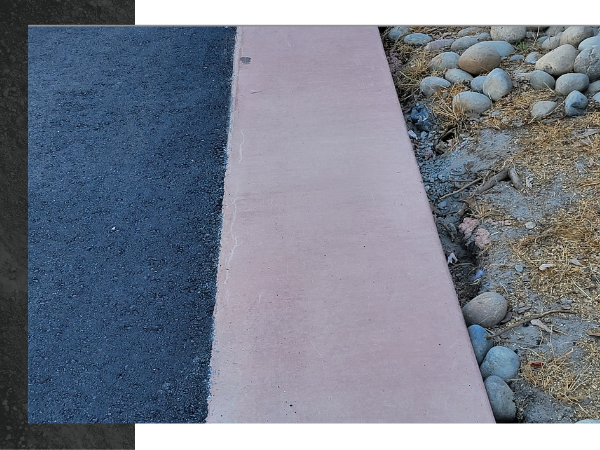 Close-up of a retaining wall between pavement and soil