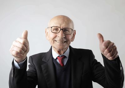 Image of an older man giving two thumbs up