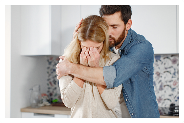 man comforting a woman