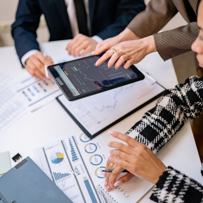 group of professionals looking at data on tablet