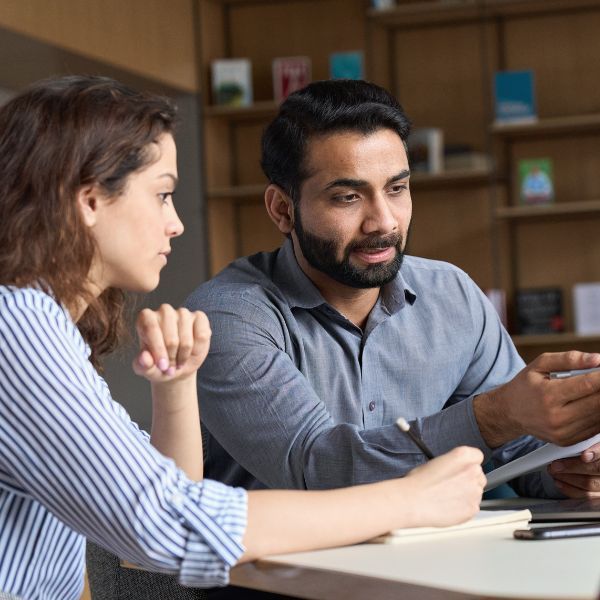 two employees at a meeting two employees at a meeting