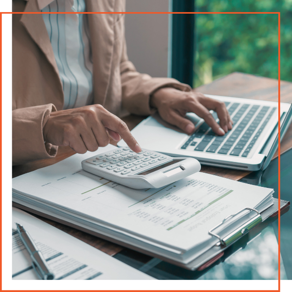 person on laptop and calculator