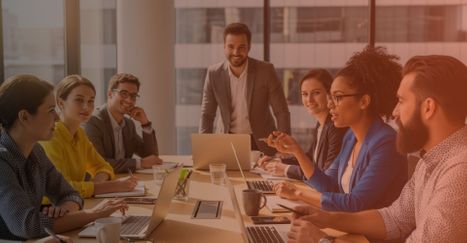 A diverse team of colleagues collaborating professionally in a bright, modern office.
