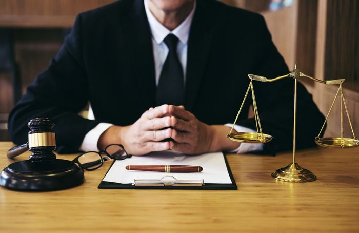 lawyer sitting at desk with hands together