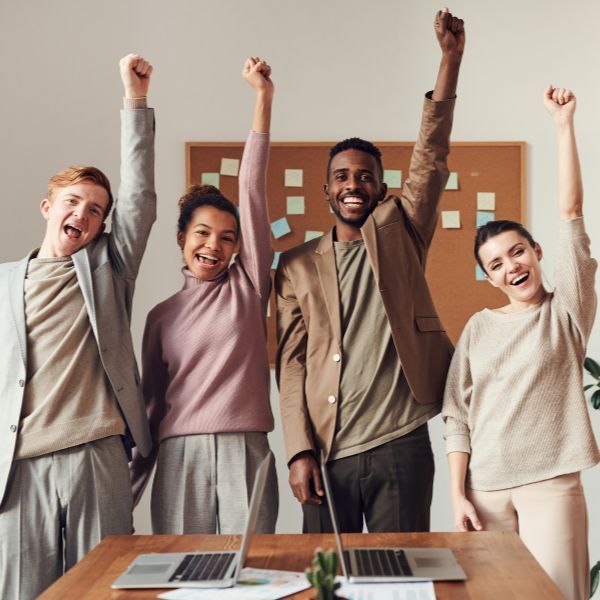 happy employees punching fists in the air happy employees punching fists in the air