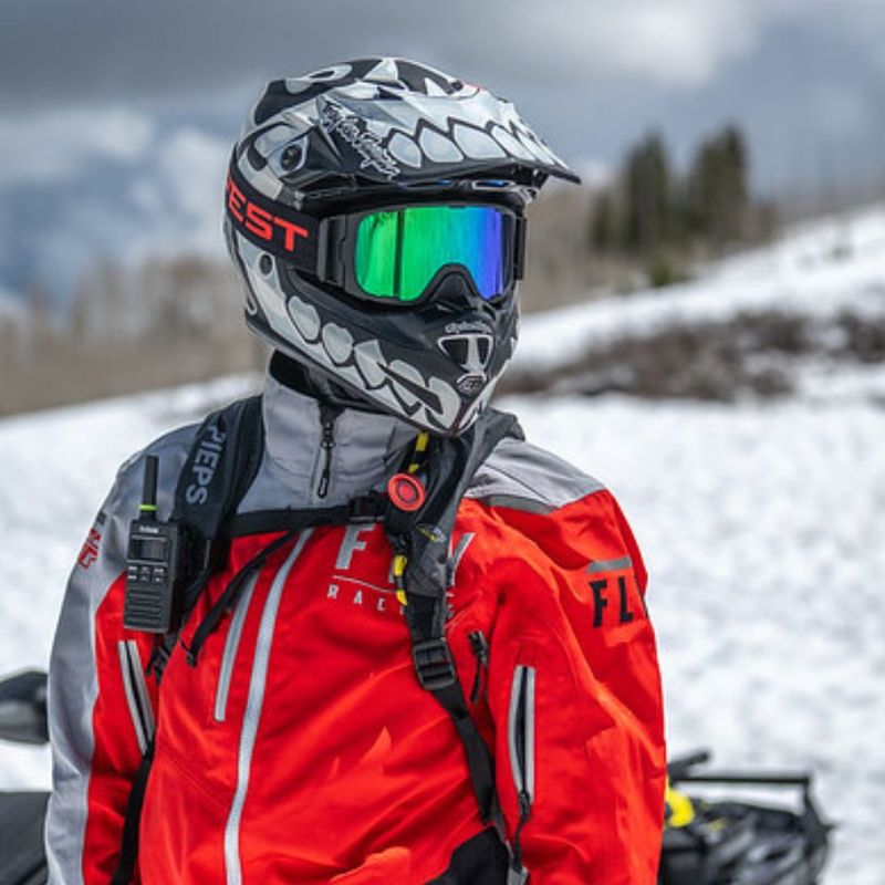 a person wearing snow attire with googles and a helment