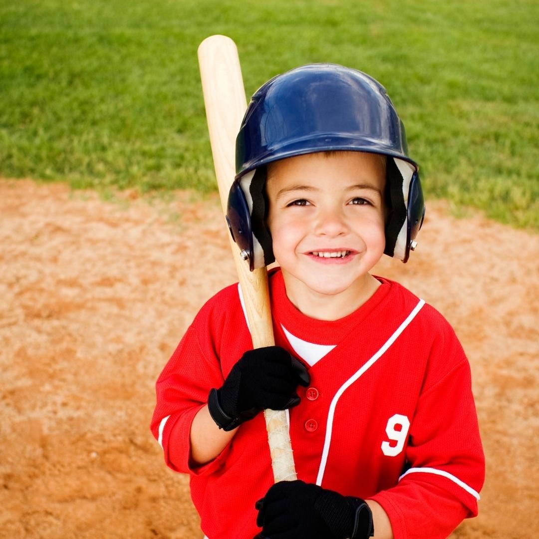 Little boy with bat and helmet