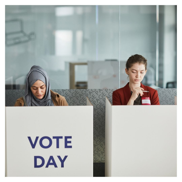 two people at voting booth