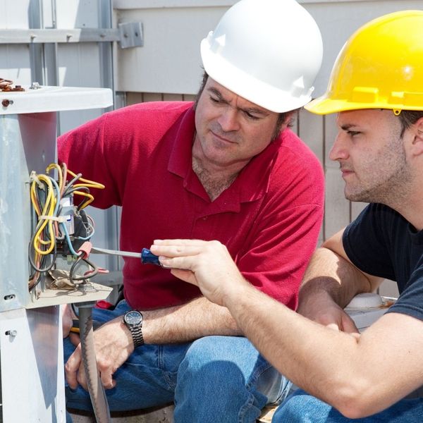 HVAC techs working together to diagnose an AC problem