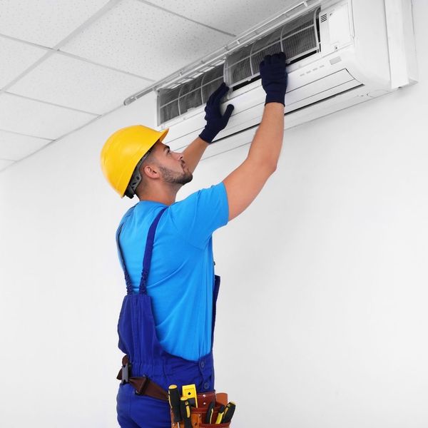 AC tech working on a residential unit