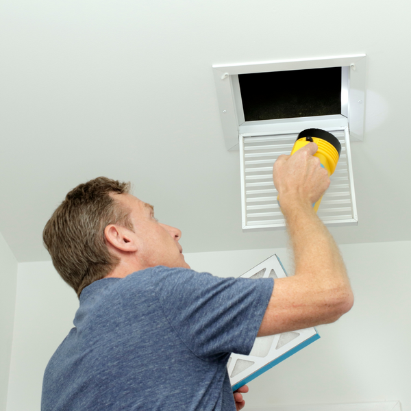 HVAC technician diagnosing duct issues HVAC technician diagnosing duct issues