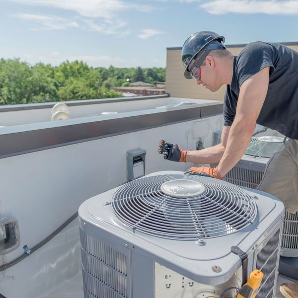 technician performing maintenance on unit