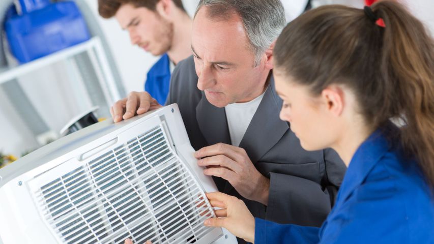 HVAC techs diagnosing issues with AC