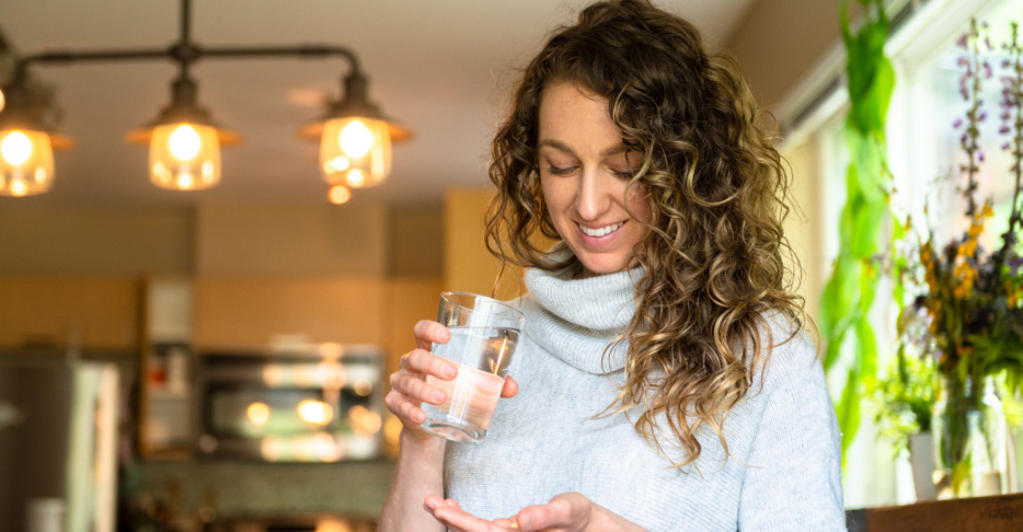 Lady about to take a supplement