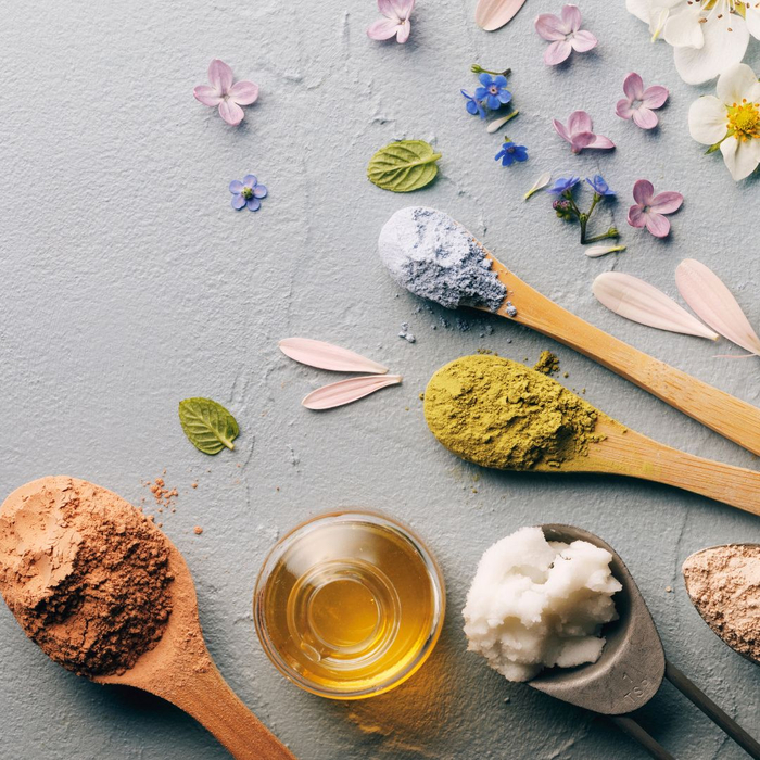 powders flowers and oil with spoons