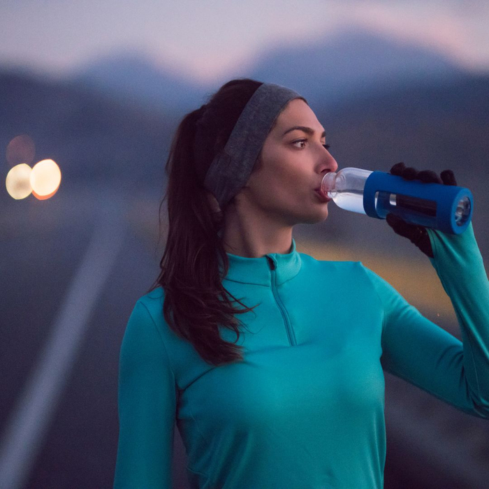 girl rehydrating during a morning run