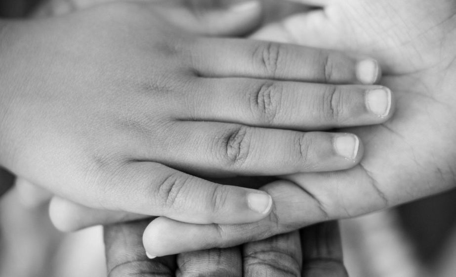 adult holding childs hand