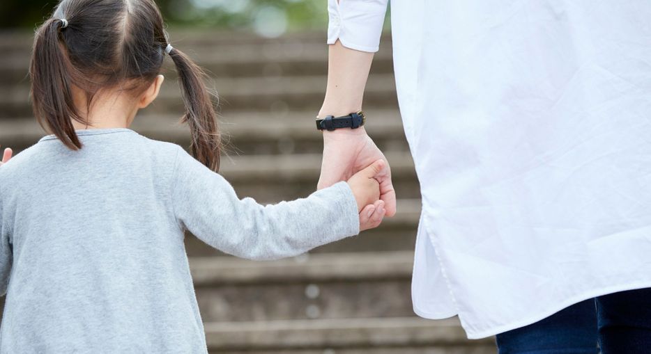 Person walking with a kid 