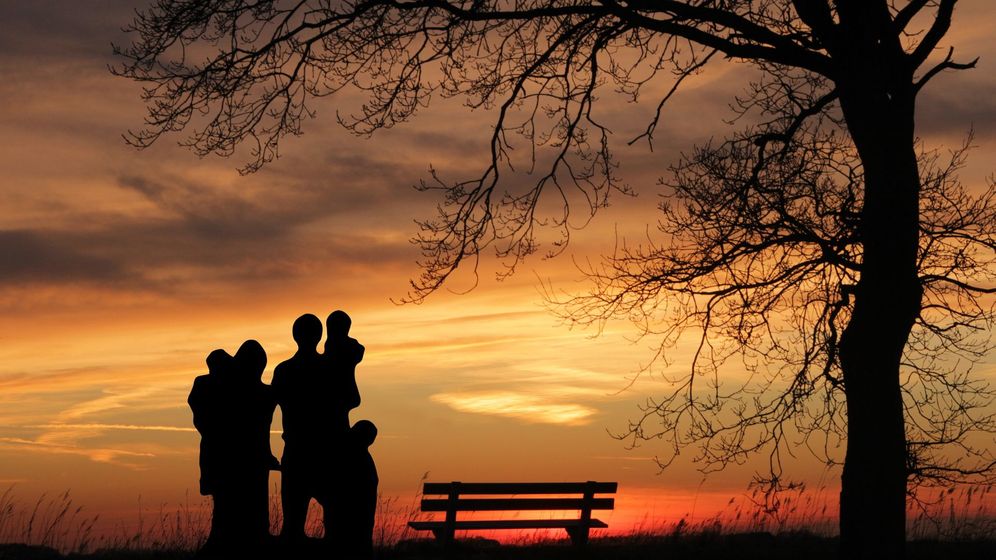 silhouette of family with children at sunset