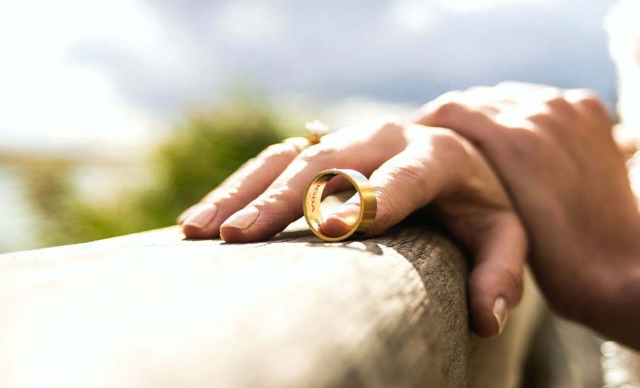 woman holding wedding ring