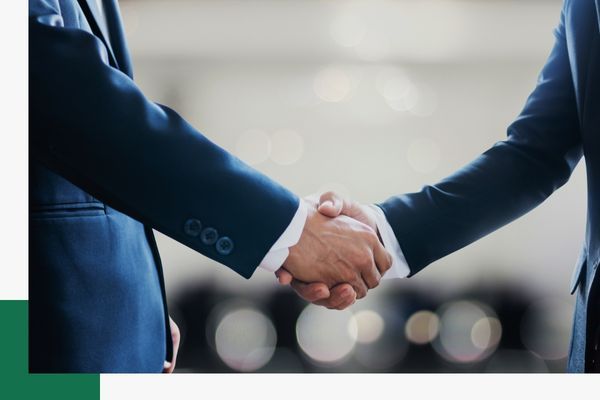 Two people in suits shaking hands