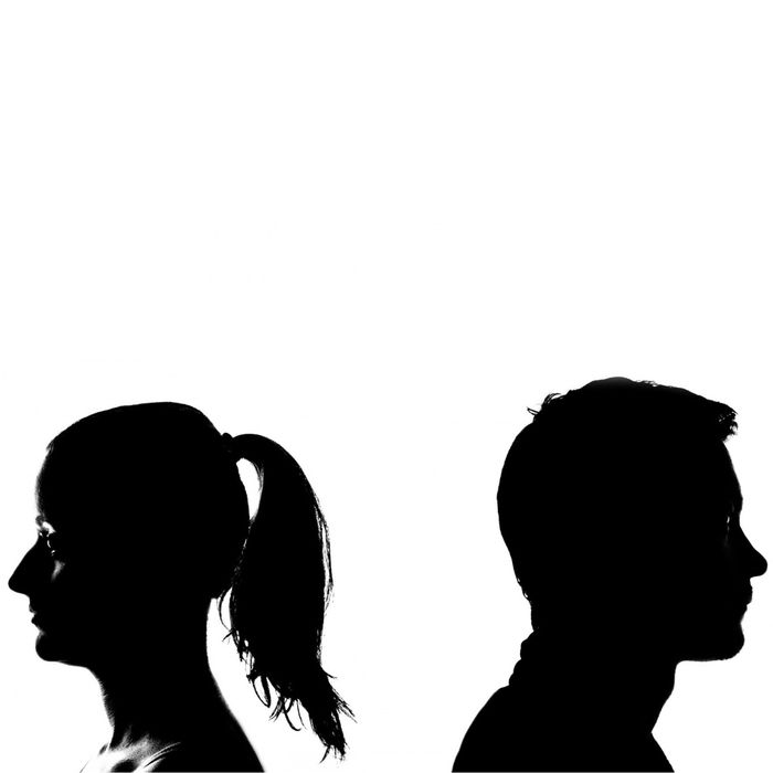 Silhouette of man and woman with their backs to one another