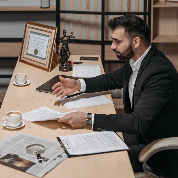 attorney talking with clients at desk