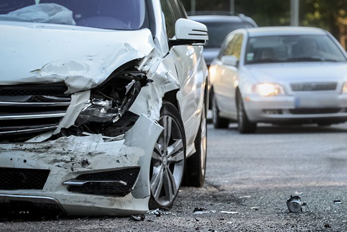 A damaged car sitting in traffic