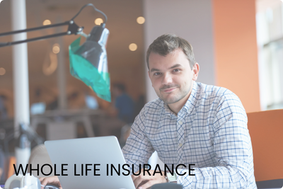 A smiling man in a blue checkered shirt sitting at a modern desk with a laptop, looking directly at the camera in a bright office setting. A smiling man in a blue checkered shirt sitting at a modern desk with a laptop, looking directly at the camera in a bright office setting.