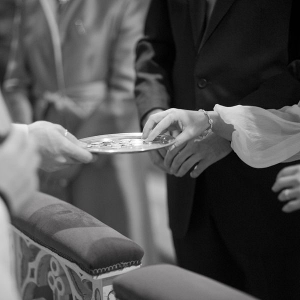 Married couple accepting offering from priest