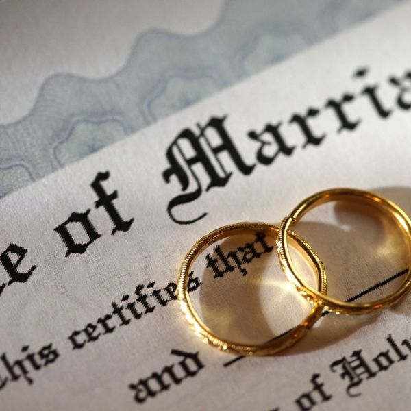 marriage certificate and wedding bands