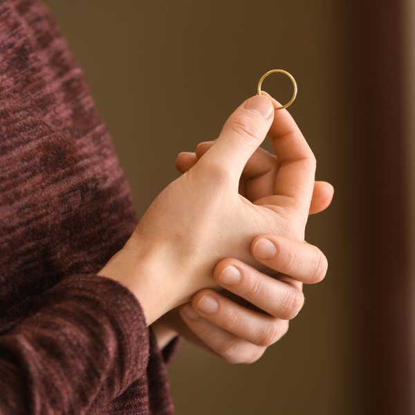 person holding wedding band