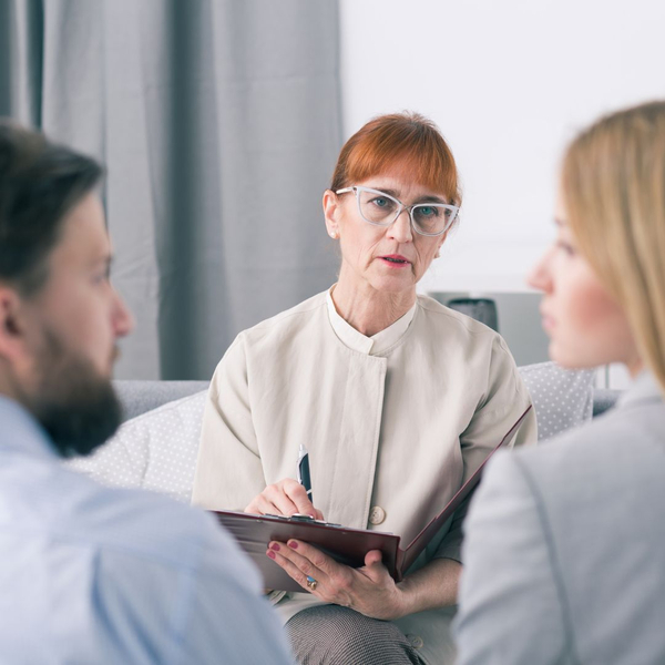 two people talking with a third party who is taking notes