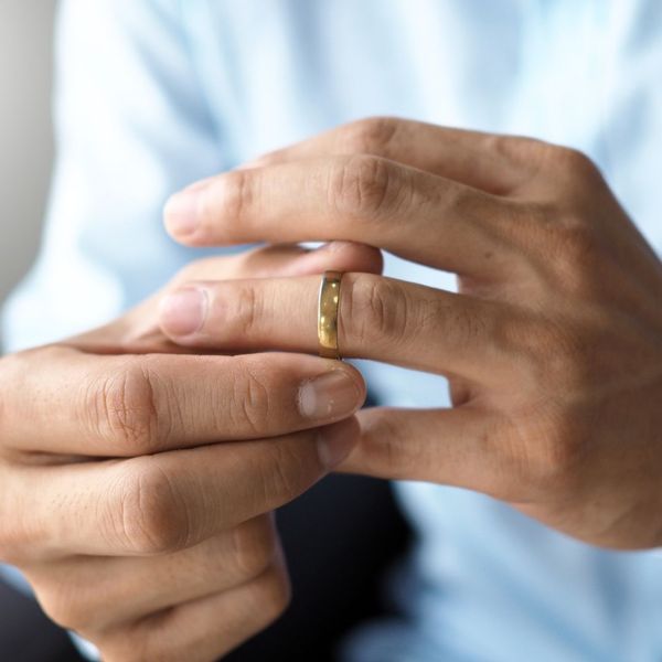 hands removing wedding ring