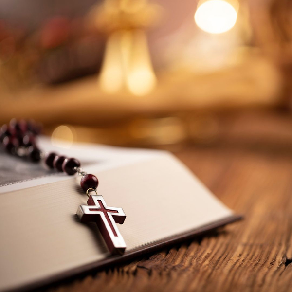 Cross necklace on top of bible