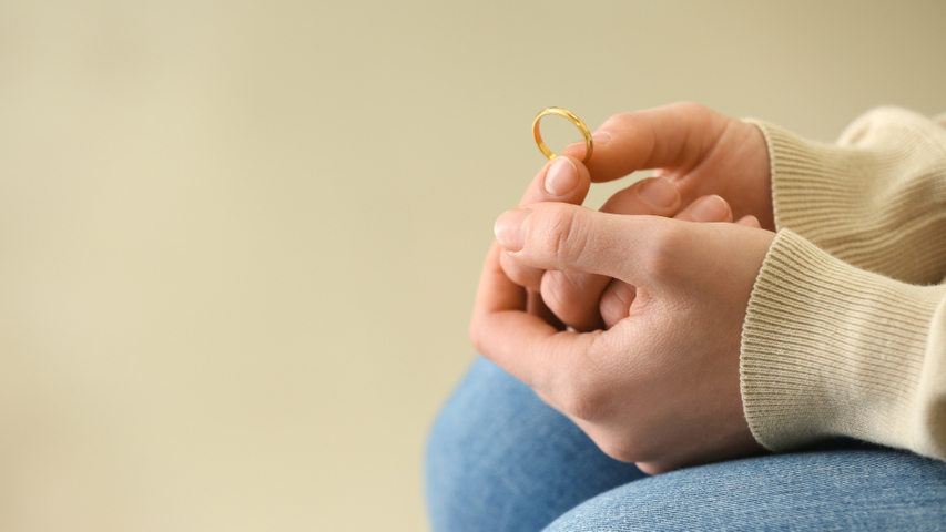 woman holding wedding ring