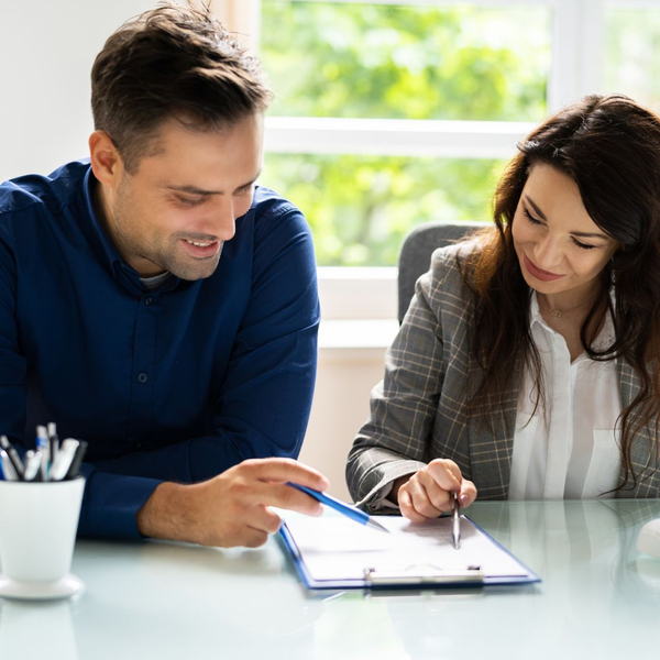 two people looking at paperwork together