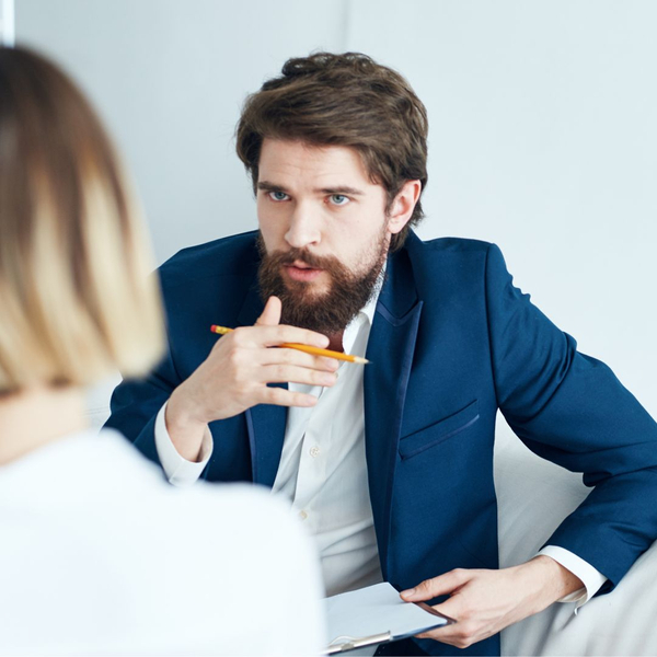 person holding clipboard talking