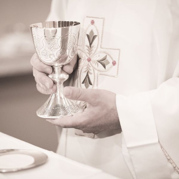 Catholic priest holding chalice