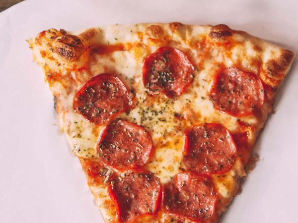 image of a slice of pepperoni New York style pizza
