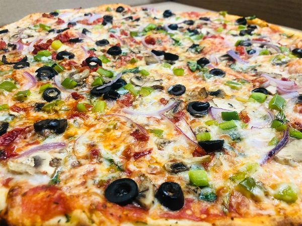 a large pizza with black olives