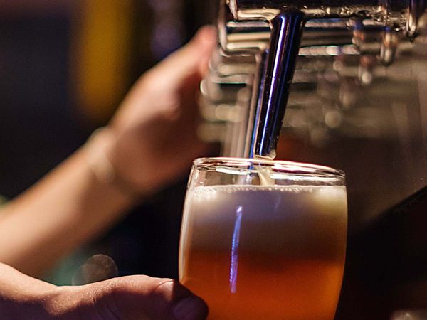 image of someone pouring draft beer